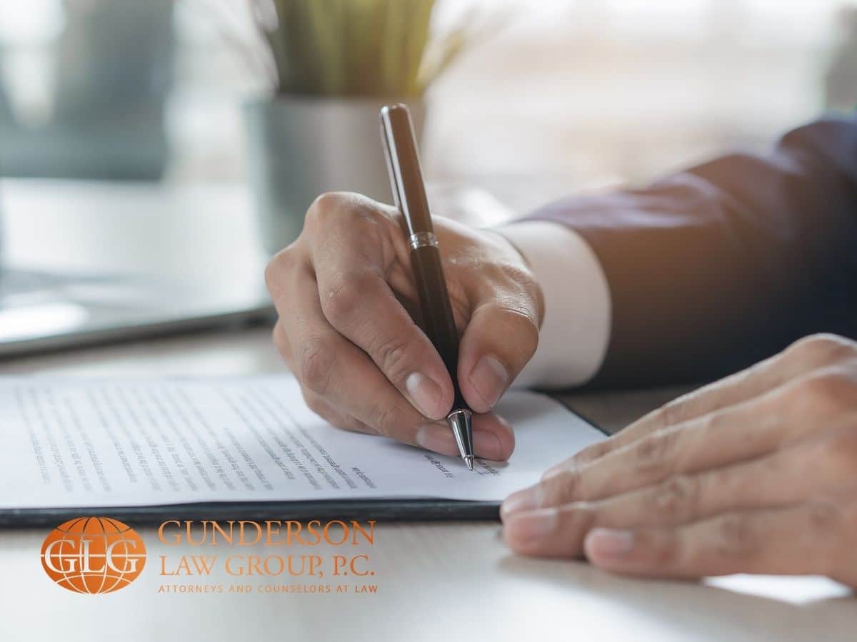 person signing a document to process your medallion signature guarantee