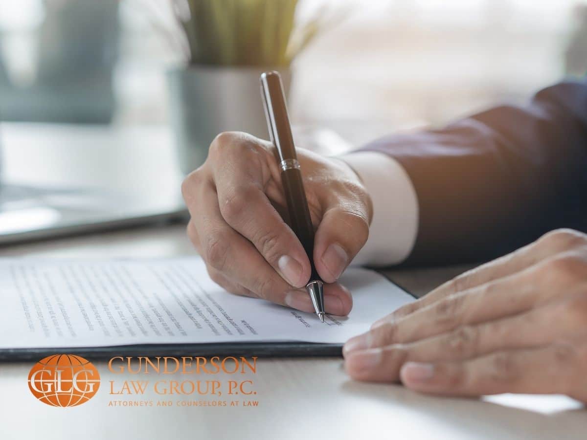  person signing a document to process your medallion signature guarantee