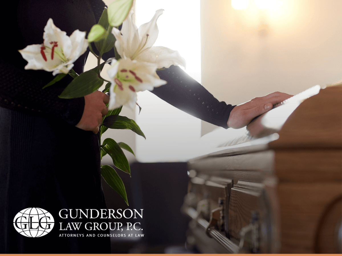 Woman with white lily flowers and coffin at her loved one funeral