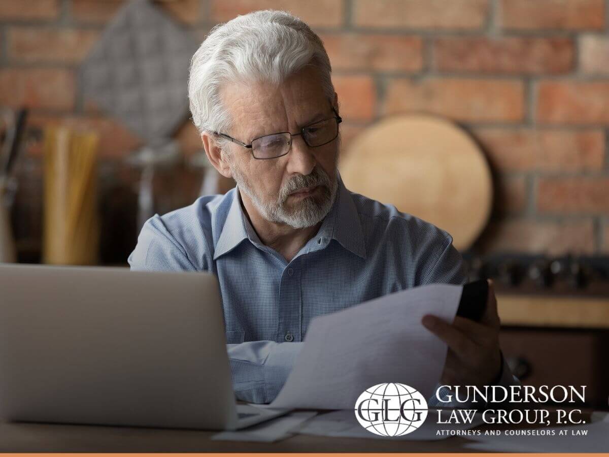 Elderly man reviewing his estate planning to include his noncitizen wife