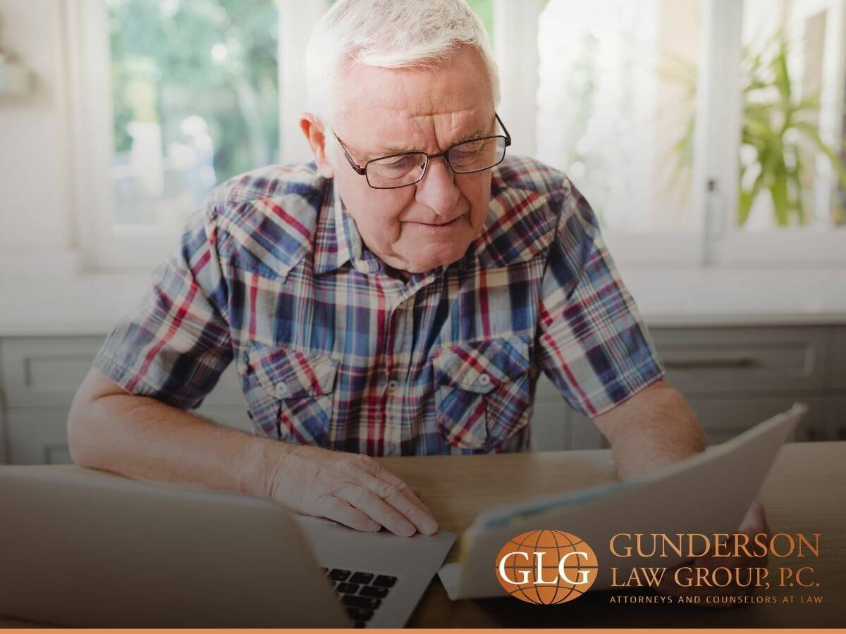 An elderly man reviewing his accounts and properties upon the death oh his loved one