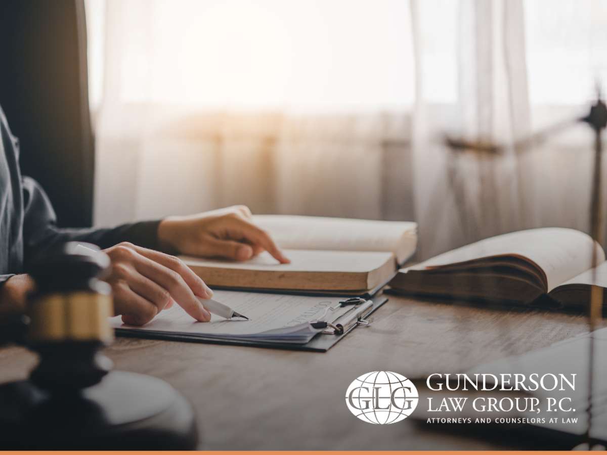 An estate planning attorney reviewing documents with legal books and a gavel on the desk, symbolizing the management of real estate with a mortgage in the event of a client's death