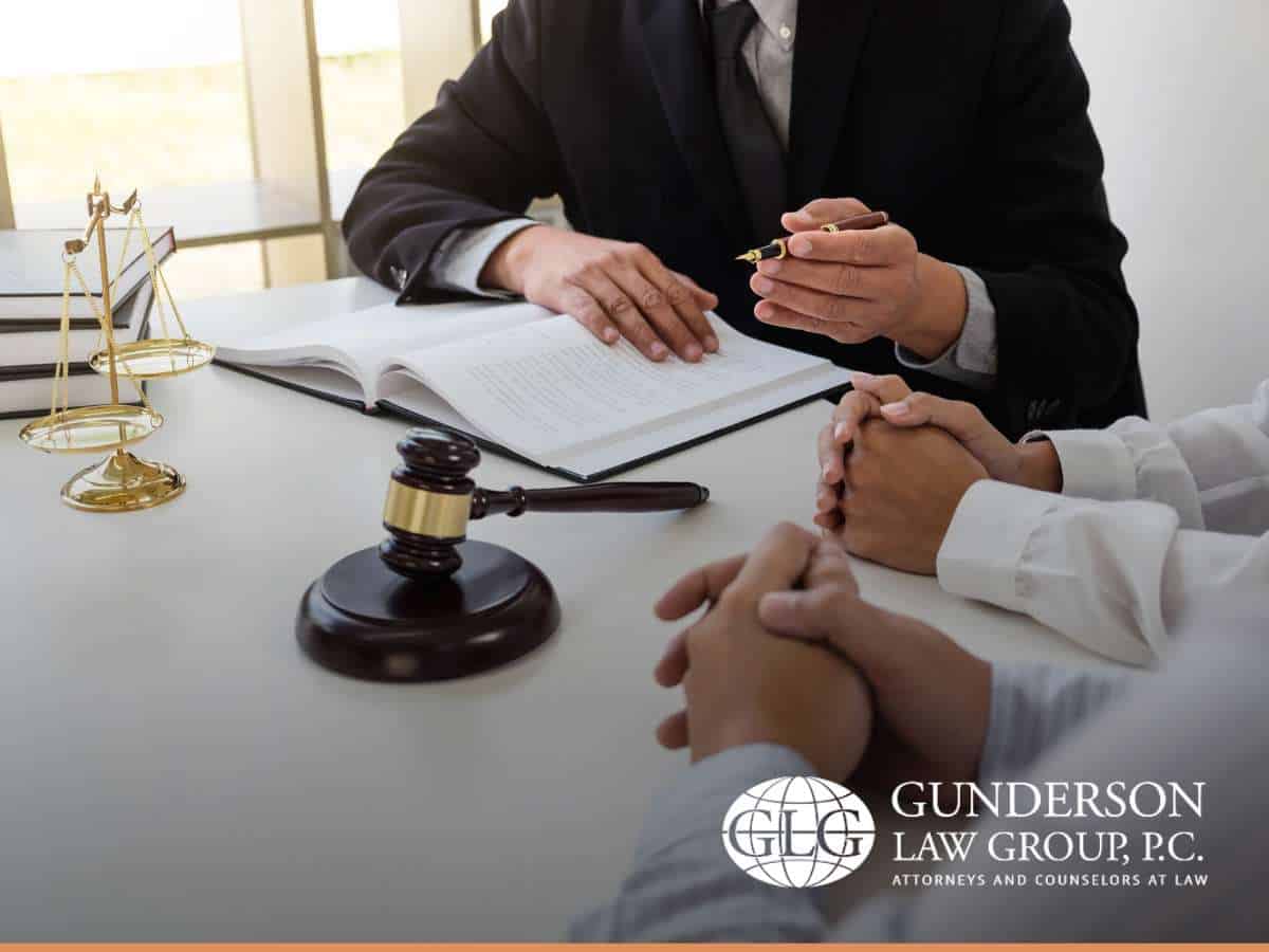 Attorney guiding a couple through legal documents, emphasizing estate planning strategies for spouses.