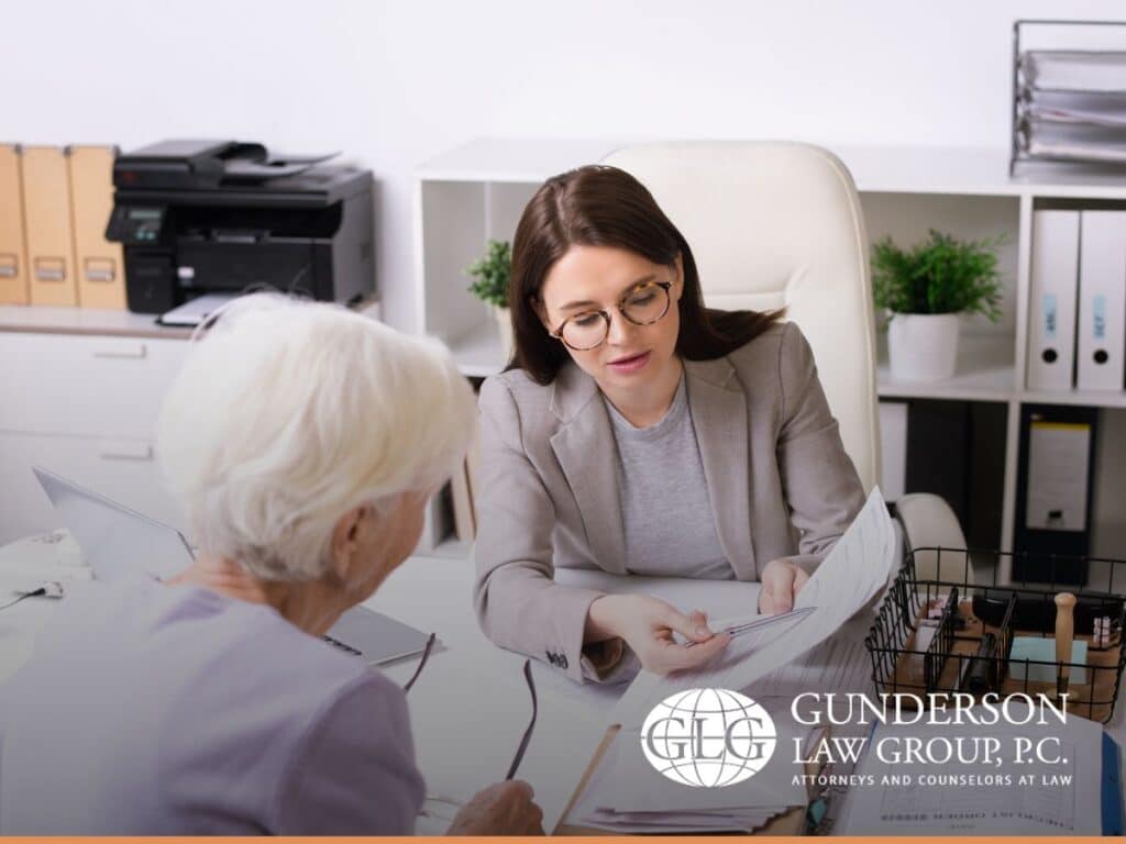 Estate planning attorney reviewing power of attorney documents with an elderly parent